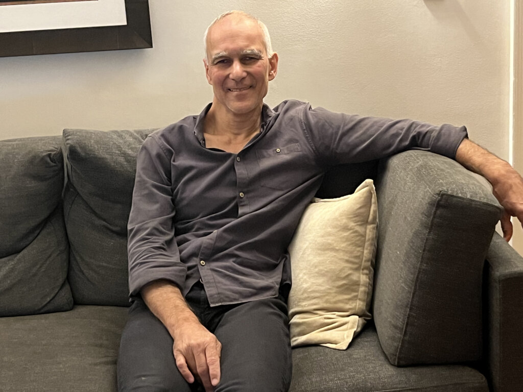 Moungi Bawendi sitting in a sofa in his home