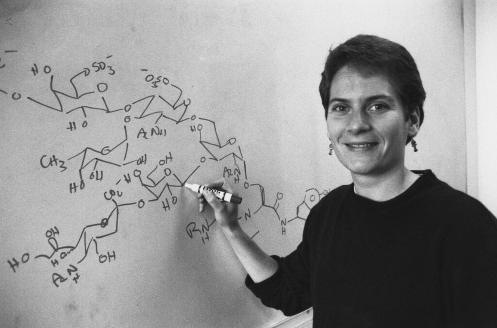 Woman writing on whiteboard