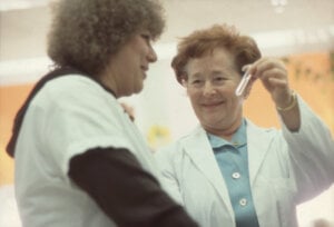 A woman showing a sample to another woman