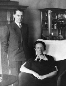 A woman sitting in front of a man