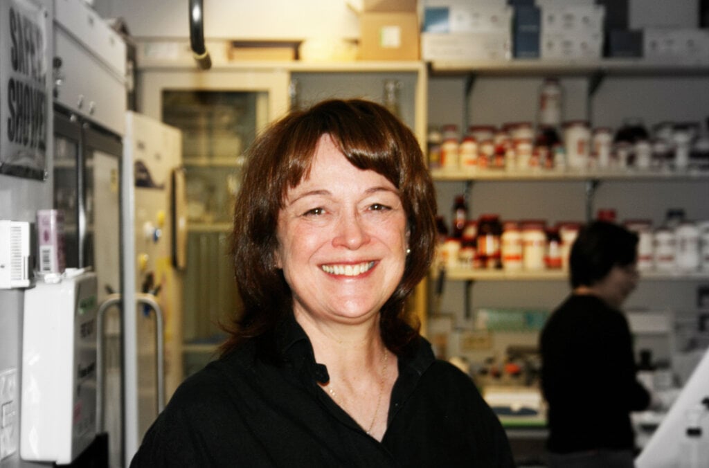 A smiling woman in a laboratory