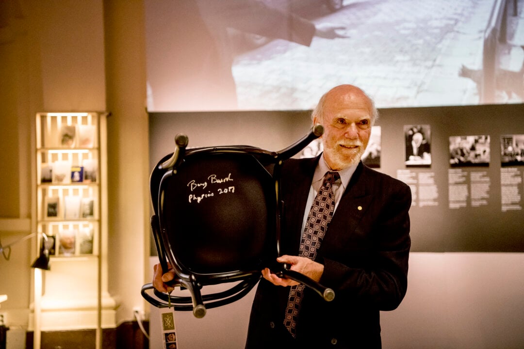 A man showing a signed chair