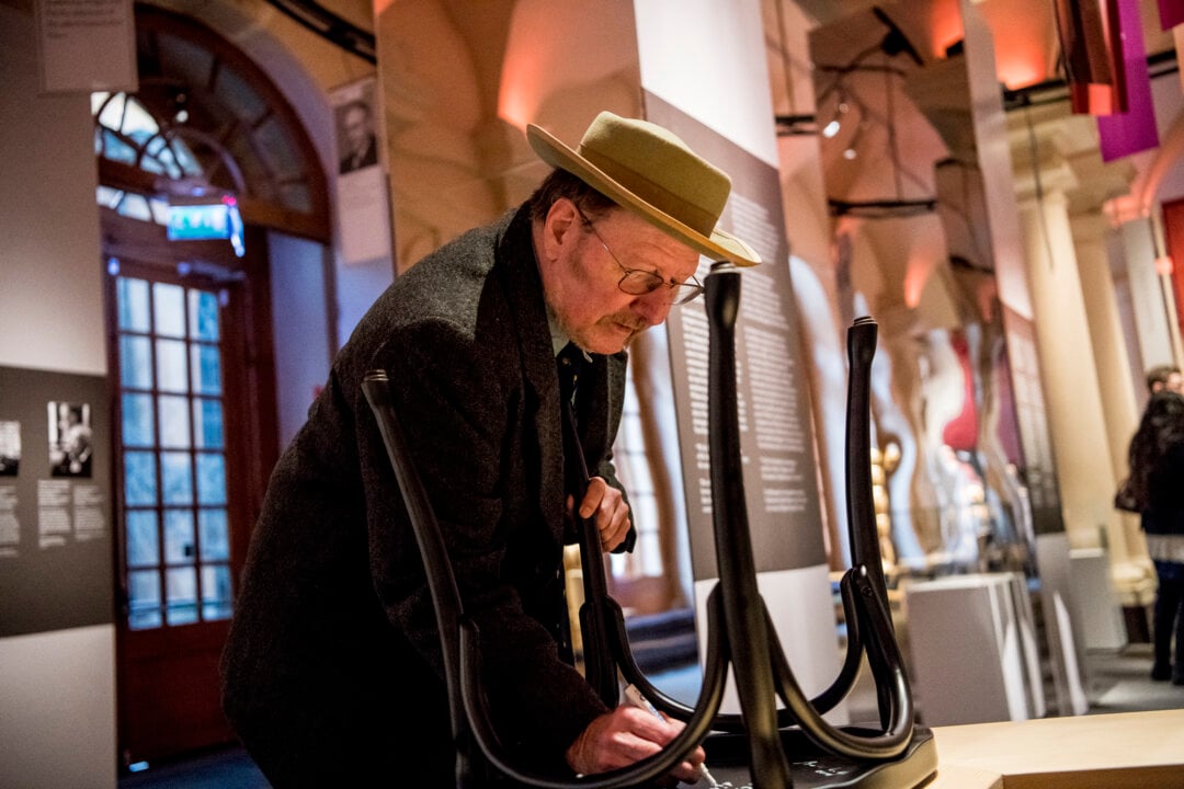 A man signing a chair