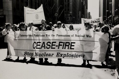 People holding a banner with the text Cease-fire