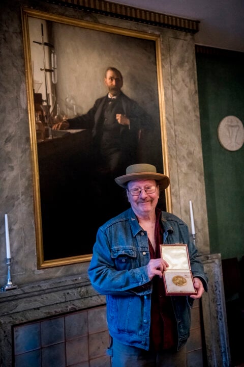 A man showing his medal