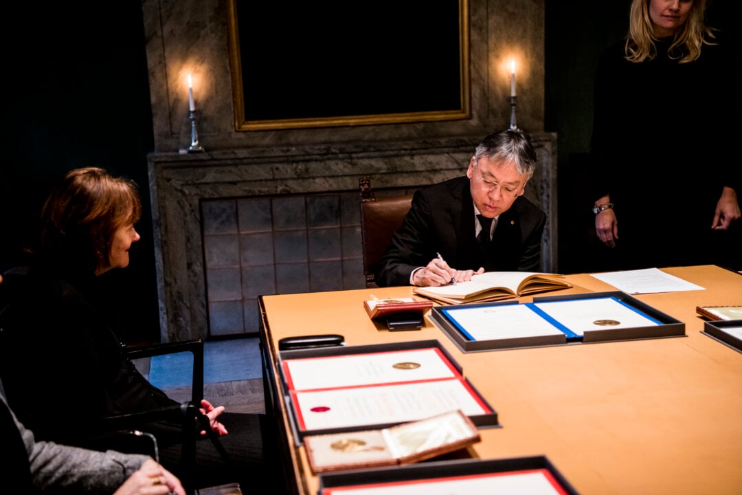 A man signing a guest book