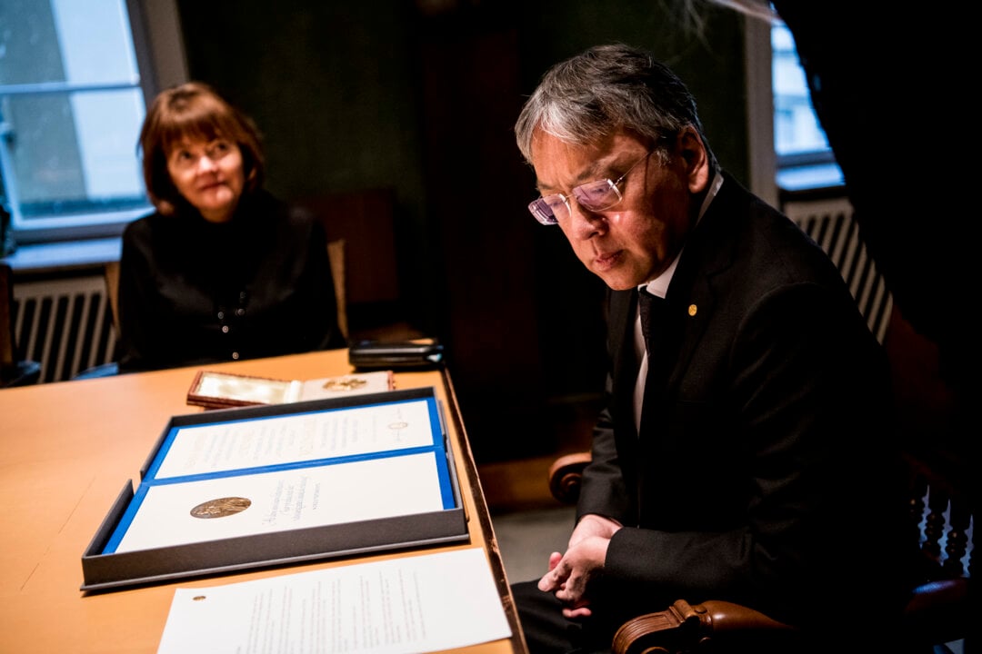 A man looks at his diploma