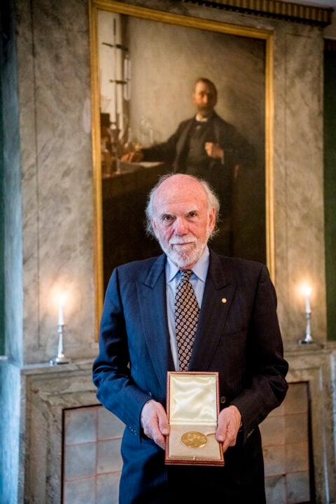 A man showing a medal