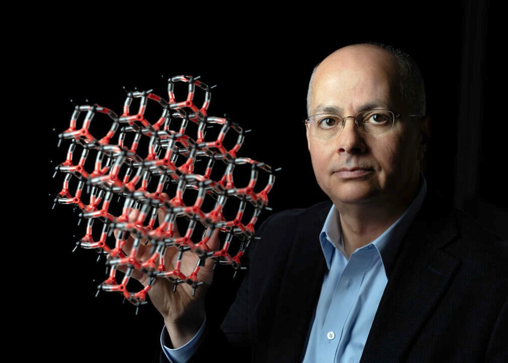 Photo of Omar Yaghi with a chemistry model