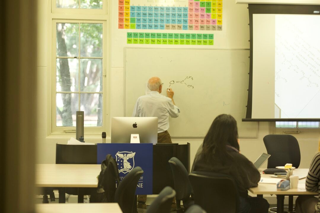 A man writing on a board