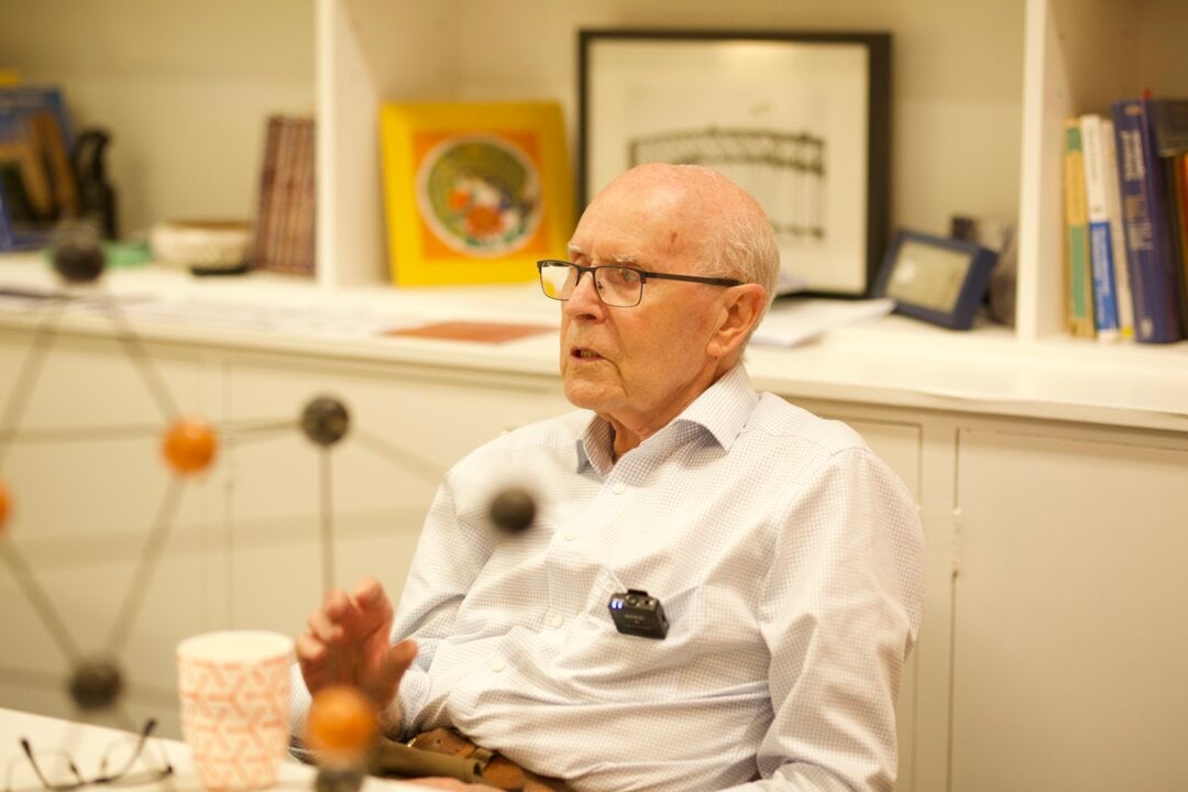 A professor sitting at a desk