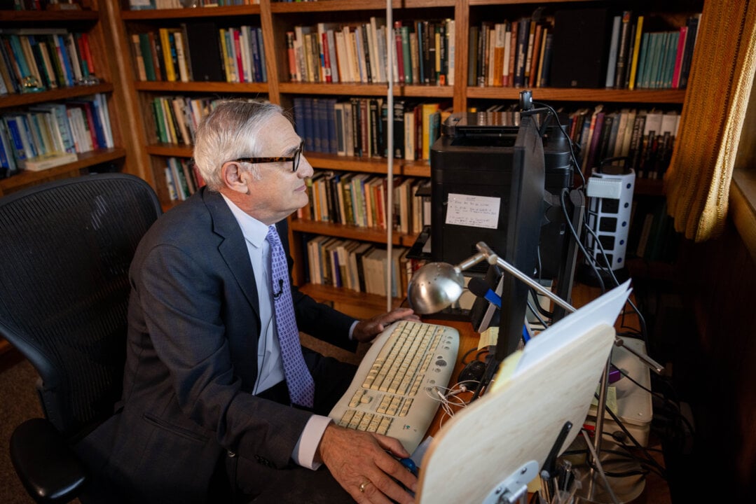 A man in front of a computer