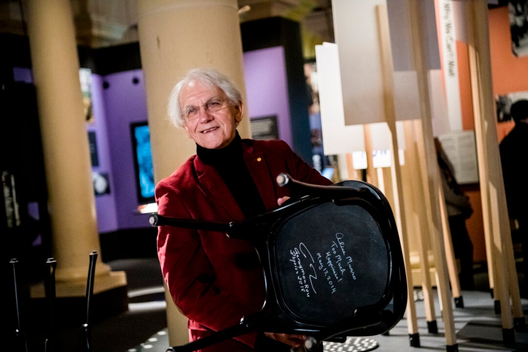A man showing a signed chair