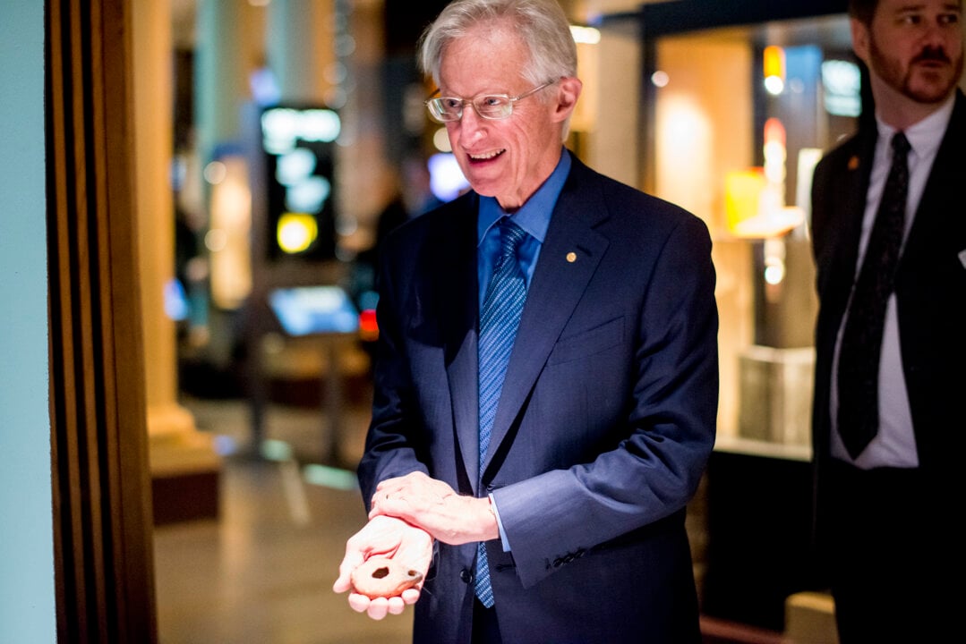 A man showing an ancient lamp
