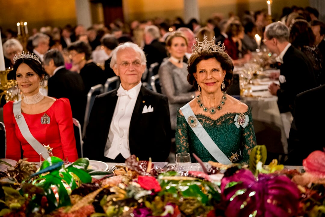 A man and two women at a banquet