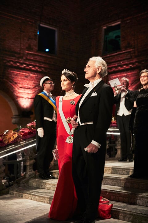 A man and a woman proceeding down stairs