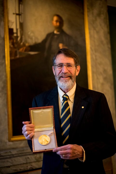 A man showing his medal