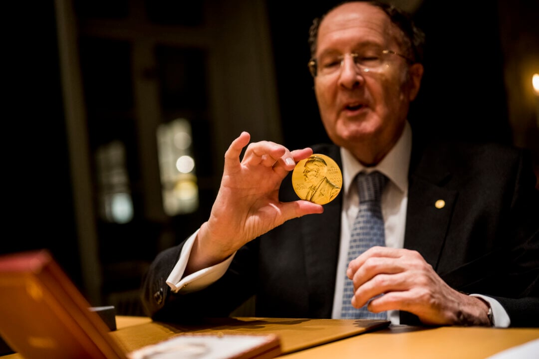 A man showing his medal