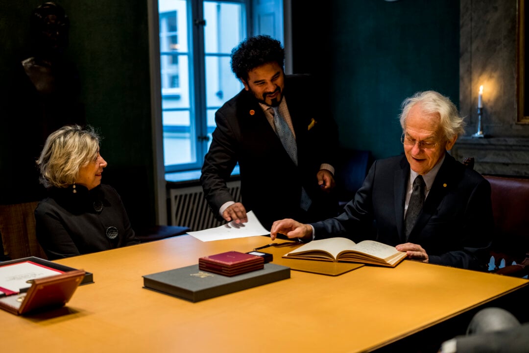 A man signing a guest book