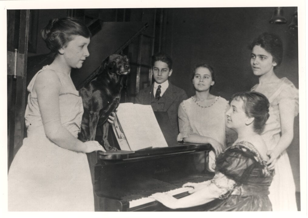 A family gathered around a piano