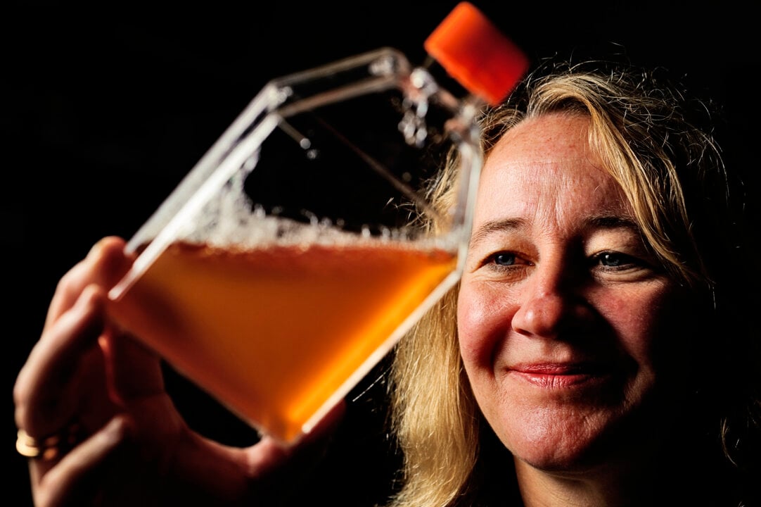 A woman holding a flask