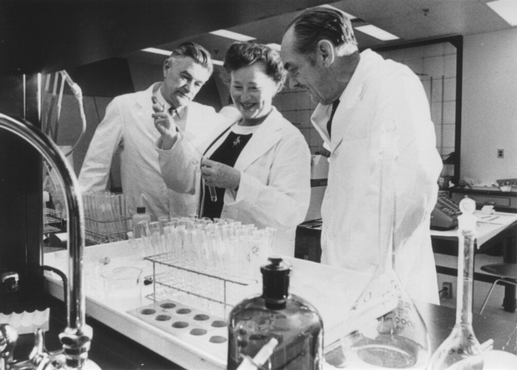 A woman and two men in a laboratory