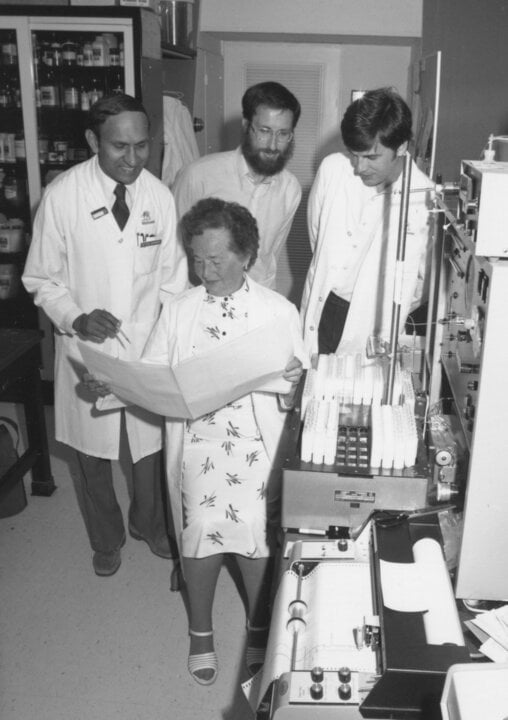 A woman and three men in a laboratory