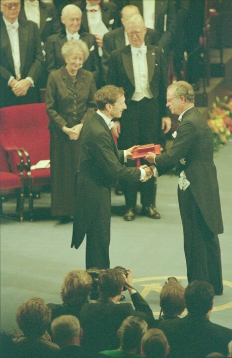 A man receiving a prize on a stage