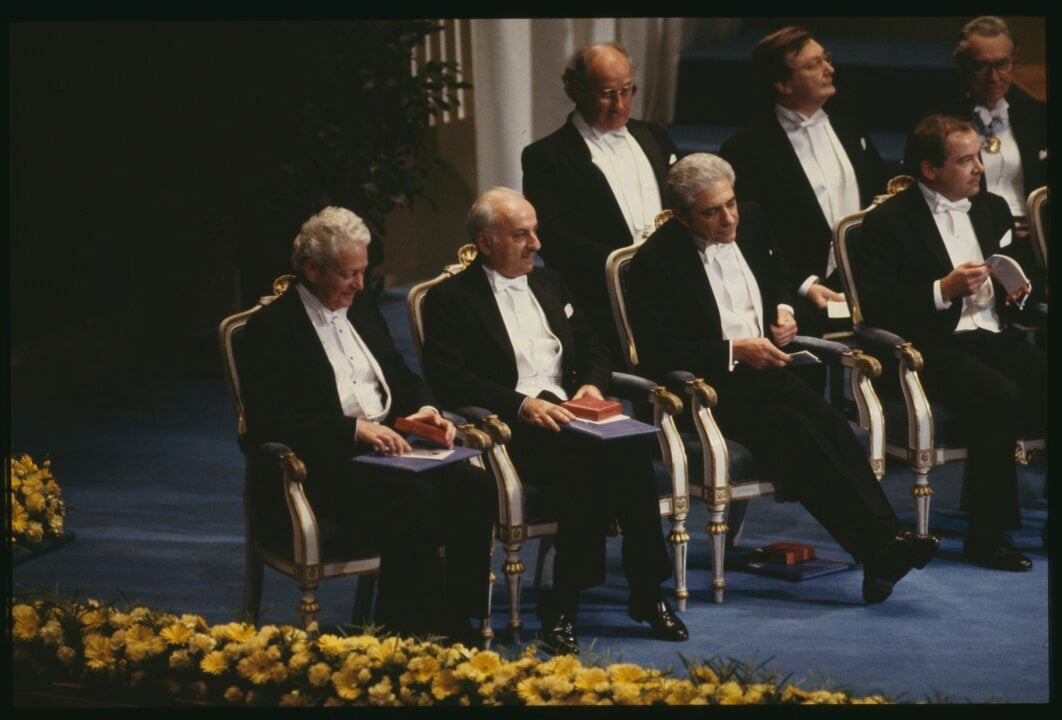 Four men sitting on a stage