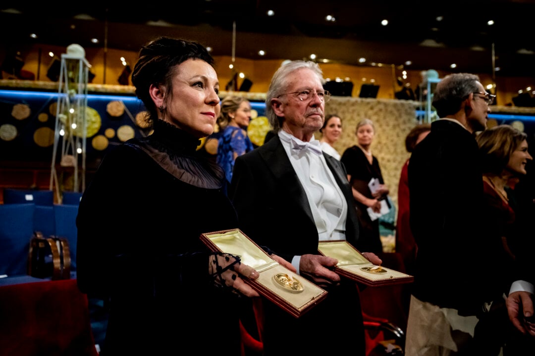 A man and a woman showing their medals