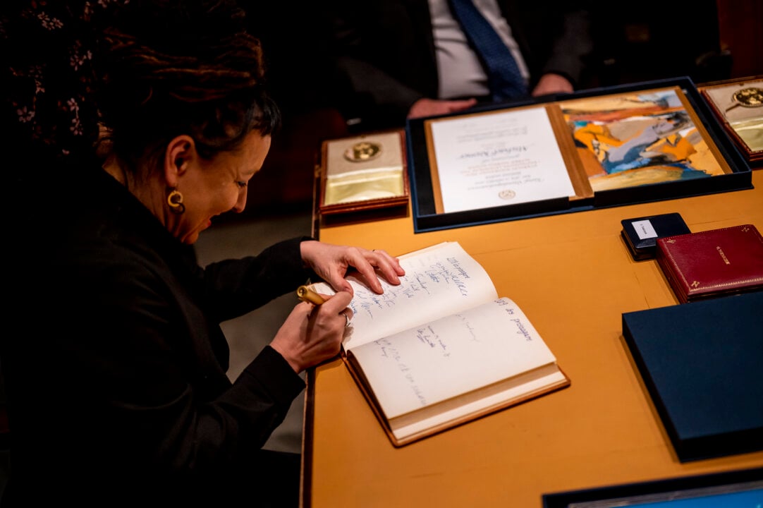 A woman signing aguest book