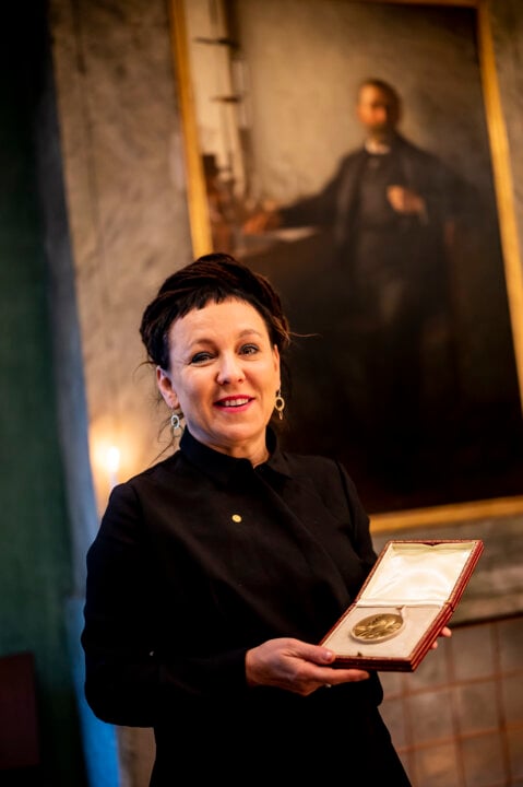 A woman showing her medal