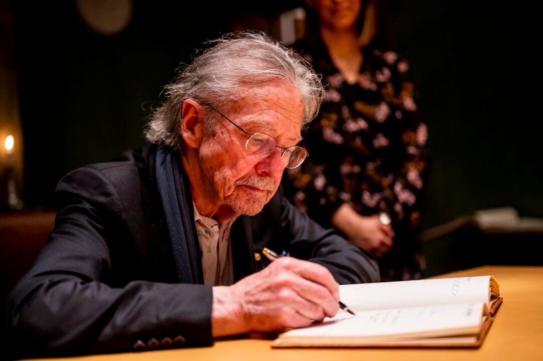 A man signing aguest book