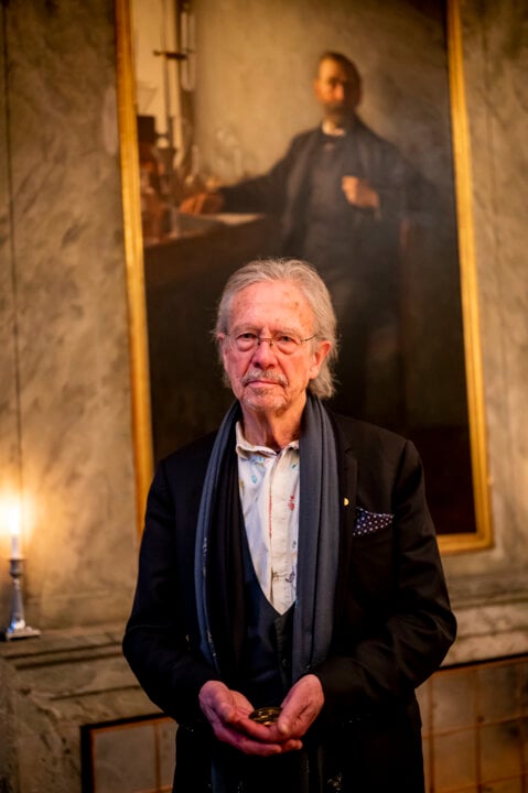 A man showing his medal