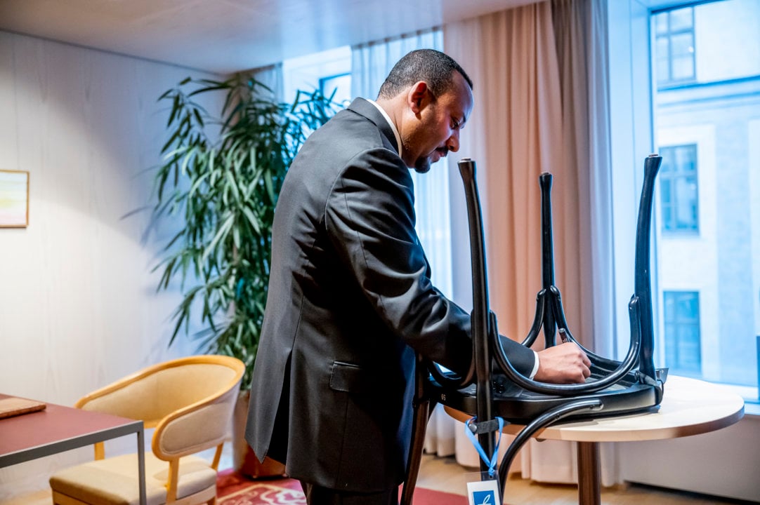 Abiy Ahmed Ali autographs a chair