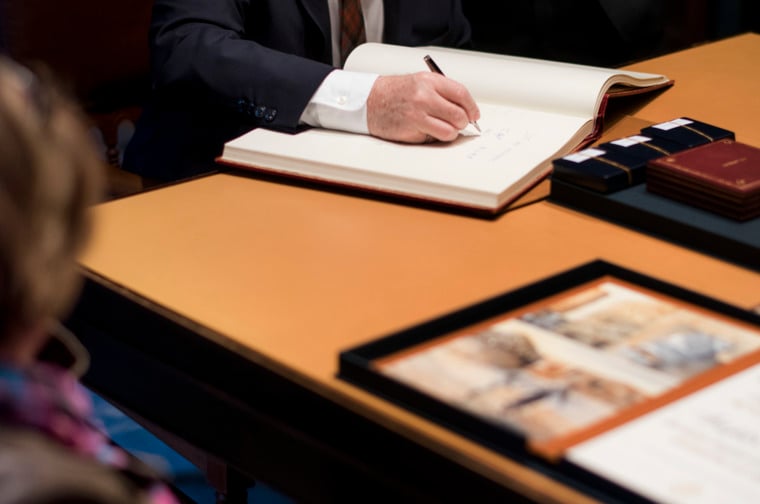 Arthur B. McDonald signs the Nobel Foundation's guest book, signed by the Laureates since 1952, during his visit to the Nobel Foundation on 12 December 2015.