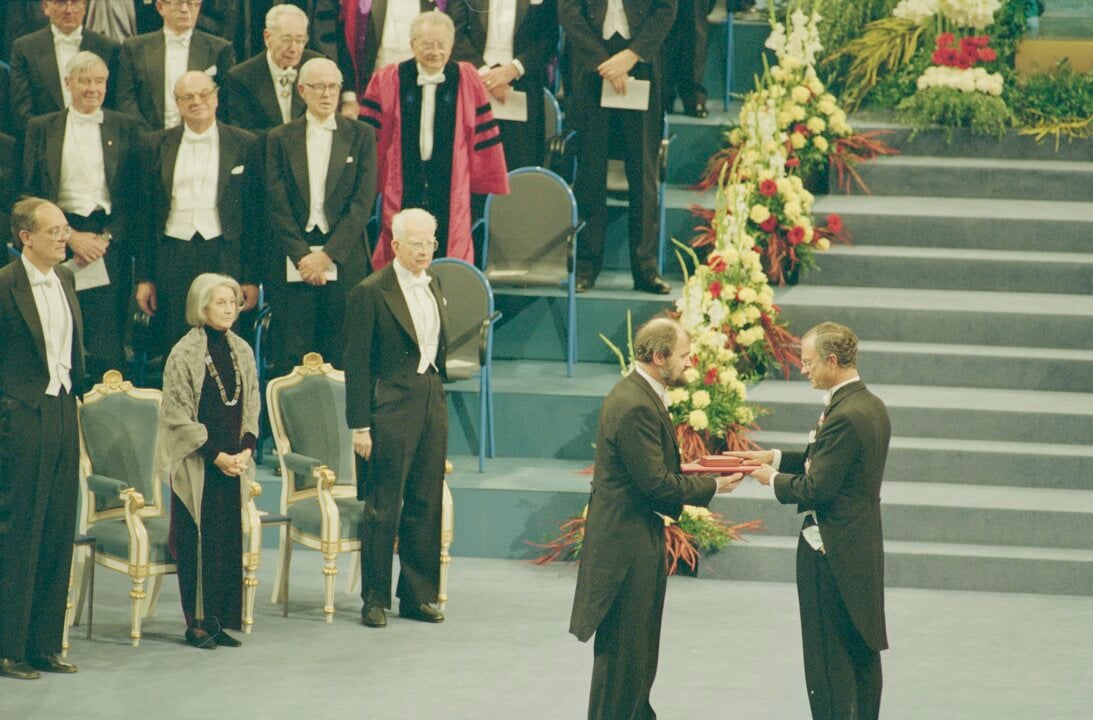 A man handing over a prize to another man