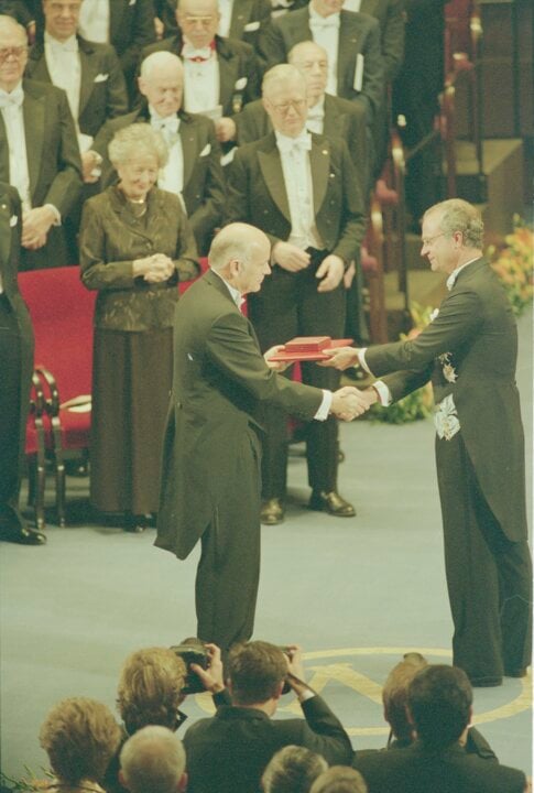 A man hands over a prize to another man