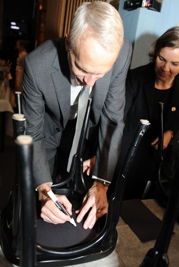 Like many Nobel Laureates before him, Brian K. Kobilka autographs a chair at Bistro Nobel at the Nobel Museum in Stockholm