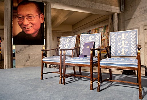 Three empty chairs with a big photo in the background